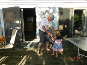 On the porch in Michigan, Dad grabs my farm princess for a few spins. She loves to dance; it runs in her blood just like farming. 